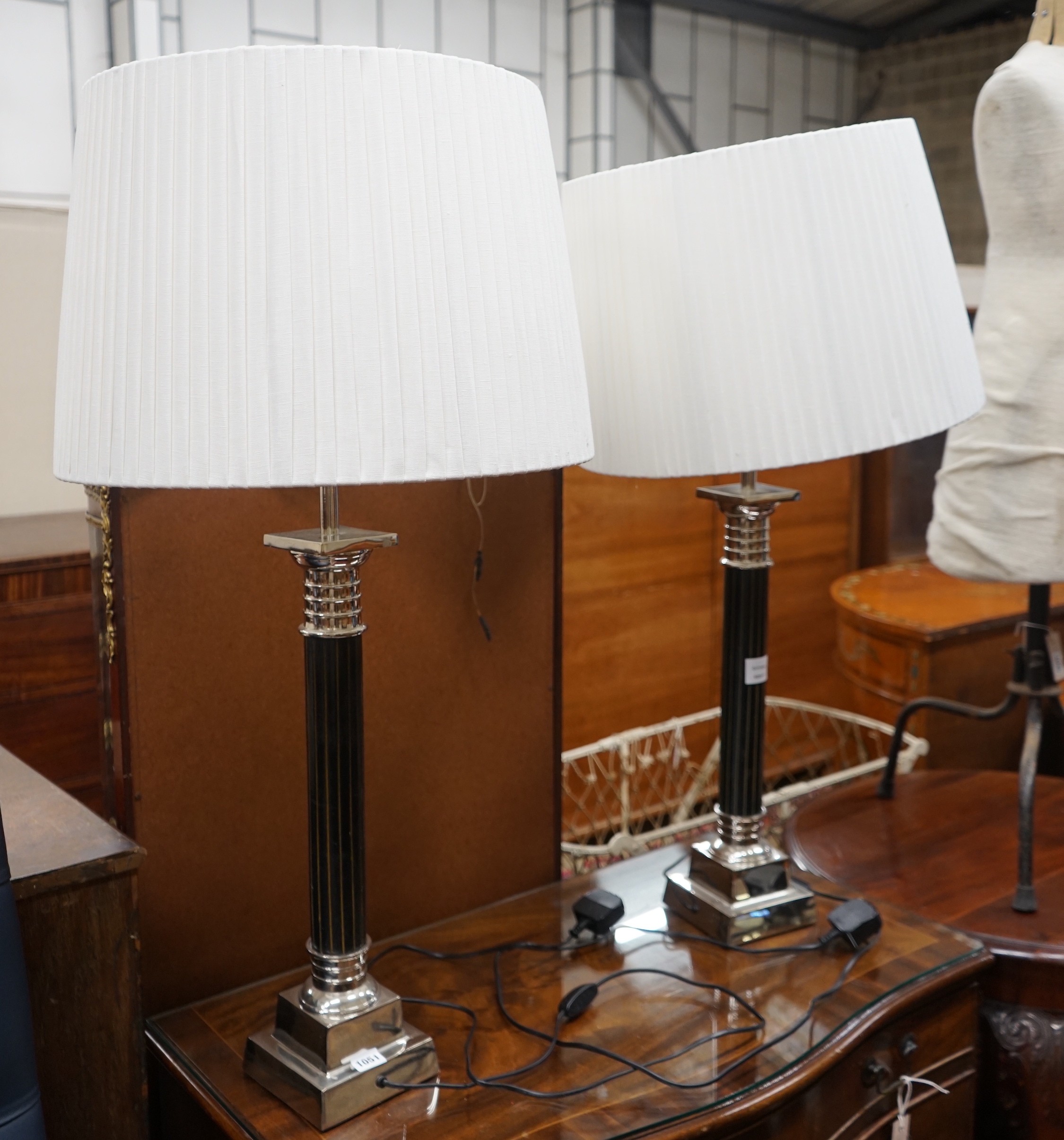 A pair of Oka gilt metal mounted and black lacquer table lamps and shades, height with shades 97cm